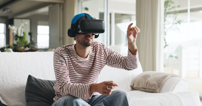 Gaming, metaverse and virtual reality with man on sofa in home for interactive experience. Online, video game and vr headset with person in apartment for immersive entertainment or streaming