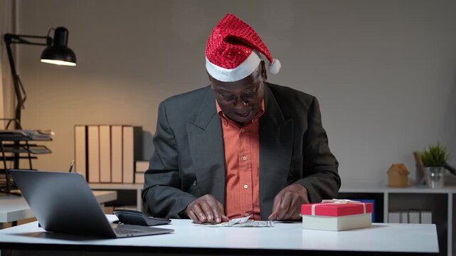 African american businessman counting christmas bonus money