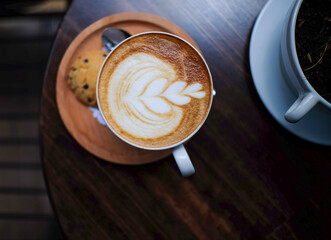 cup of cappuccino on wooden table