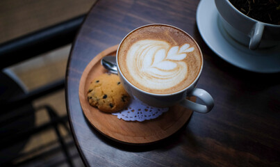 cup of cappuccino on wooden table