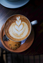 cup of cappuccino on wooden table