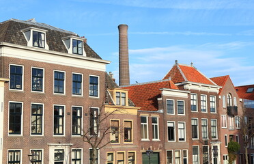 Oude Vest Building Facades with Power Station Chimney in the Background in Leiden, Netherlands
