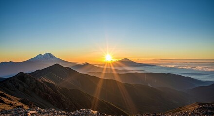 Majestic Sunrise over a Mountain Range with Dramatic Sun Rays and Clouds