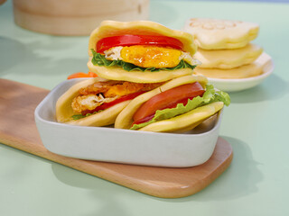 Delicious Breakfast Sandwiches with Eggs and Vegetables in Soft Buns Ready to Enjoy