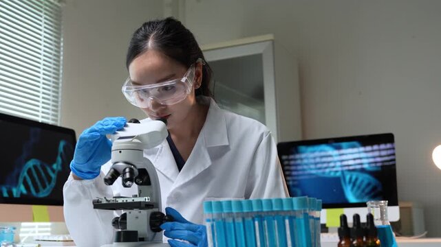 Female scientist analyzing dna using a microscope in a laboratory - Powered by Adobe