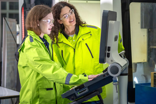 Female Engineers Teamwork in Robot Control Inspection in Factory Two Women Engineers Monitoring Industrial Machine Operation on Digital Screen Robotic Engineers Checking Precision Control System.