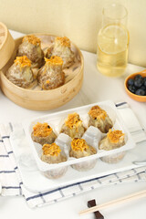 Chinese Siu Mai Dim Sum Dumplings with Fish Roe Topping in Bamboo Steamer Traditional Asian Cuisine
