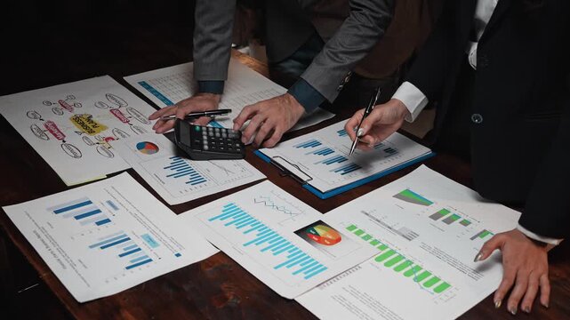 Business colleagues analyzing financial charts and data on desk - Powered by Adobe