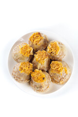 Chinese Siu Mai Dim Sum Dumplings with Salted Egg Yolk Topping on White Plate