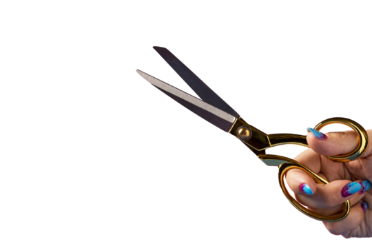 Close up of a hand holding ornate gold handled scissors against a stark Transparent PNG background with vibrant nail polish