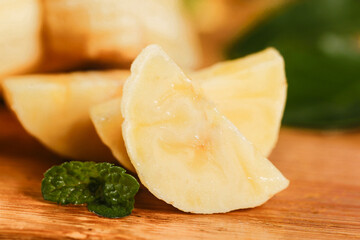 Fresh Sliced Small Emperor Bananas from Guangxi China with Mint on Wood Board