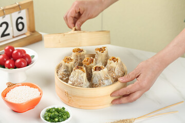 Handmade Glutinous Rice Dumplings with Pork Siu Mai in Bamboo Steamer - Traditional Asian Dim Sum Preparation