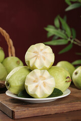Fresh Golden Guava Fruits from Guangxi China with Creamy Interior on Wooden Table