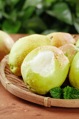 Fresh Korla Pears from Xinjiang China in Wicker Basket with Water Droplets