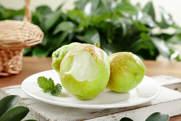 Fresh Kurla Pears from Xinjiang China on White Plate with Mint Garnish
