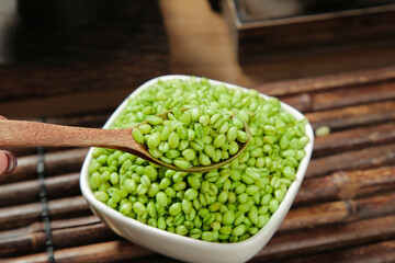 Fresh Green Wheat Kernels in Bowl with Wooden Spoon - Healthy Organic Grain Ingredient