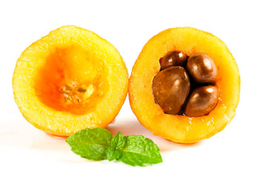 Fresh Loquat Fruit Cut in Half with Seeds and Mint Leaves