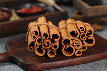 Natural Cinnamon Sticks Bundle on Wooden Board - Aromatic Spice Seasoning for Cooking and Baking