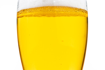 A glass of beer is shown with a lot of foam on top
