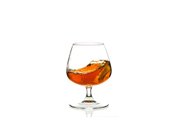A glass of liquor is poured into a glass cup