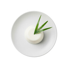 Pristine transparent coconut panna cotta with a vibrant miniature palm leaf garnish on minimalist matte white plate, isolated on transparent, commercial dessert concept.