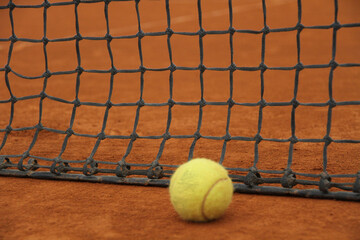 Tennis Ball Near the Net on Clay Court &ndash; Focus, Challenge and Motivation Concept