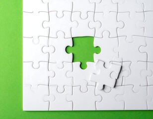 Close-up of incomplete jigsaw puzzle on a vibrant green surface