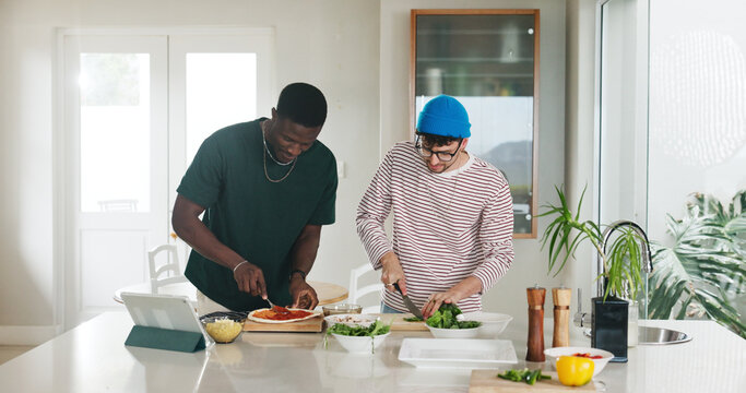 Cooking, ingredients and pizza with friends in kitchen of home together to follow online recipe tutorial. App, tablet and video instructions with roommate people in apartment for meal preparation