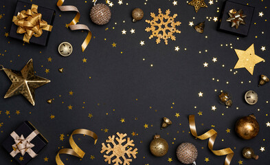 Christmas gift boxes and holiday ornament objects on black background with copy space