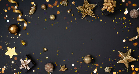 Christmas decoration objects on black background top view with holiday ornament and copy space in center