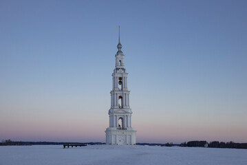 Winter dawn at the flooded old bell tower of St. Nicholas Cathedral. Kalyazin. Tver region, Russia