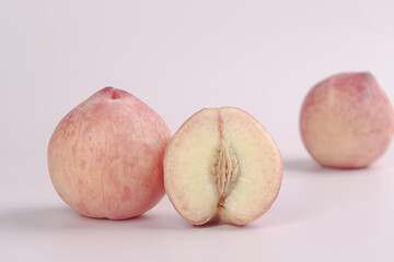 Fresh Sweet Peaches Cut in Half Showing Pit Summer Fruit on White Background