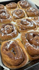 Freshly Baked Cinnamon Rolls with Icing – Close-Up of Sweet Pastry in Baking Tray