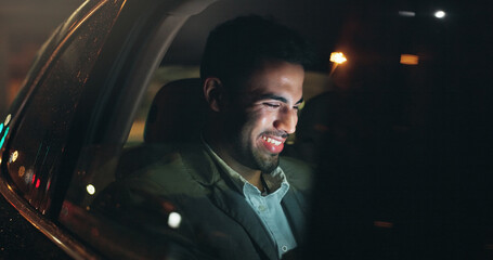 Laugh, technology and businessman in car at night in city with networking, email or communication. Travel, research and male person checking project with deadline in vehicle with commuting in town. © peopleimages.com