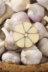 Fresh Shandong Garlic Bulbs with Cross Section Showing Cloves in Woven Basket