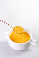 Golden Millet Pumpkin Porridge in White Cup - Healthy Breakfast Cereal