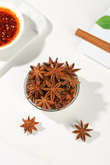 Star Anise Spices from Guangxi China with Tea Cup and Cinnamon on White Marble Background