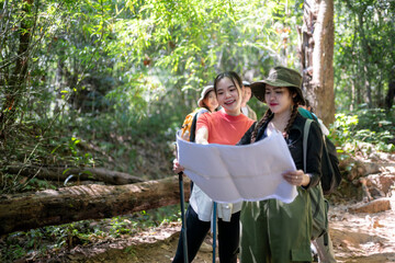 Women friends hiking exploring nature looking at map