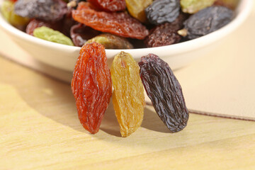 Mixed Tricolor Xinjiang Raisins - Red Golden Purple Dried Grapes in Wooden Bowl
