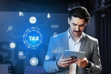 Professional man using tablet to analyze tax information in a modern office setting