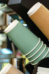 Coffee cups stacked in a cafe, ready for busy customers during morning hours
