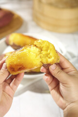 Golden Sweet Potato with Fluffy Yellow Flesh Held in Hands - Comfort Food Photography