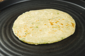 Handmade Chinese Scallion Pancake Cooking in Pan - Traditional Asian Flatbread with Green Onions