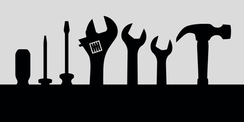 Silhouette of various hand tools arranged in a line