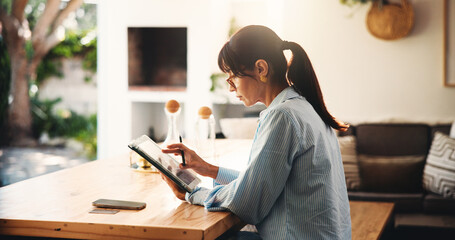 Tablet, reading and woman in home office for remote work, article research or editing newsletter....