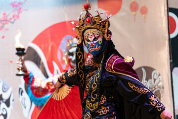 Chinese actor performs a public traditional changing face performance onstage in Chengdu, China
