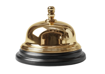 Gleaming brass call bell sits atop a dark, grainy base