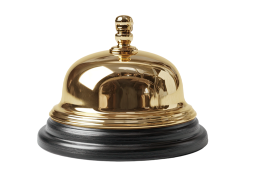 Gleaming brass call bell sits atop a dark, grainy base