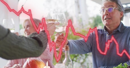 Raising and clinking stemmed wine glasses, adults toasting on outdoor patio, with red chart overlay