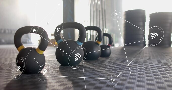 Displaying kettlebells with colored bands sitting on gym flooring, with wireless overlay